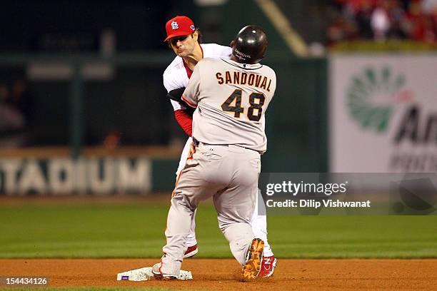 Pablo Sandoval of the San Francisco Giants crashes into Pete Kozma of the St. Louis Cardinals after pitcher Lance Lynn of the Cardinals has a...