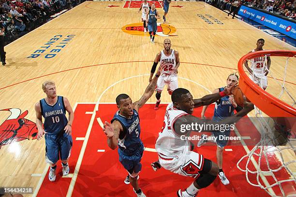 Nate Robinson of the Chicago Bulls shoots against Will Conroy of the Minnesota Timberwolves during the NBA preseason game on October 19, 2012 at the...