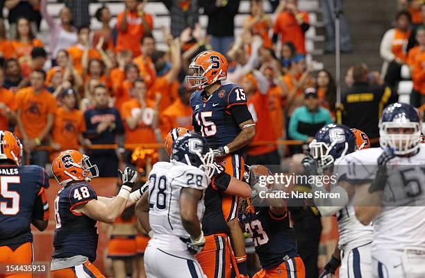 Alec Lemon of the Syracuse Orange celebrates with Prince-Tyson Gulley, Carl Cutler and Zack Chibane after a touchdown against the Connecticut Huskies...