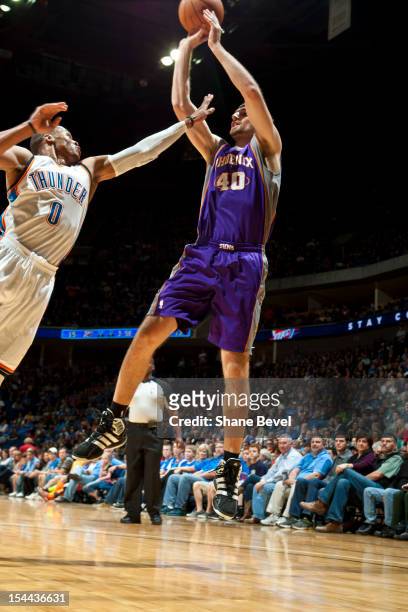 Luke Zeller of the Phoenix Suns shoots against Russell Westbrook of the Oklahoma City Thunder during a pre-season game on October 19, 2012 at the BOK...