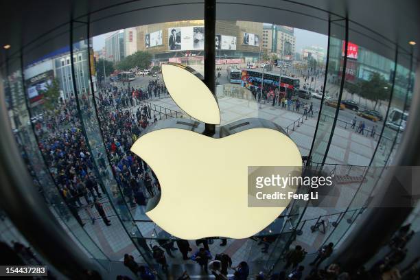Apple staff members celebrate as customers coming the Wangfujing store on October 20, 2012 in Beijing, China. Apple Inc. Opened its sixth retail...