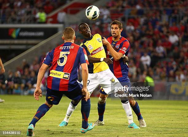 Bernie Ibini of the Mariners and Josh Mitchell of the Jets contest possession during the round three A-League match between the Newcastle Jets and...