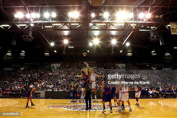 Luke Schenscher of the 36ers and Brad Hill of the Taipans compete at the tip-off during the round 3 NBL match between the Adelaide 36ers and the...