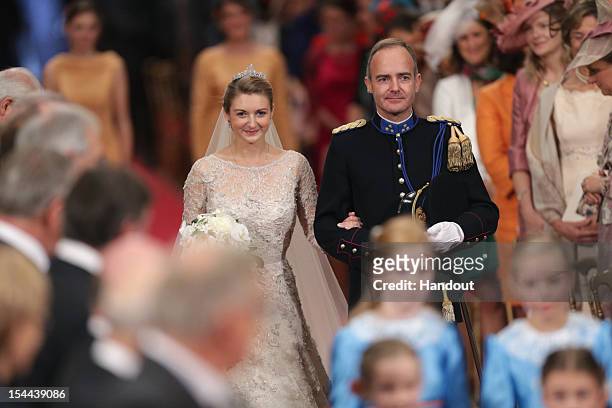 In this handout image provided by the Grand-Ducal Court of Luxembourg, Princess Stephanie of Luxembourg walks down the aisle with her brother Count...