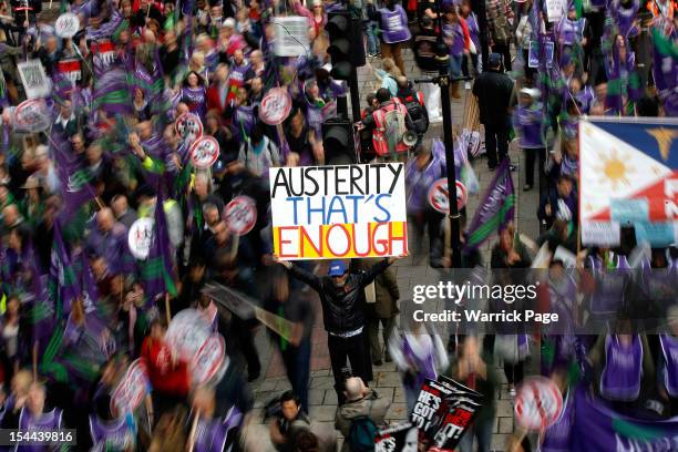 Protestor holds up a banner reading 'Austerity - That's Enough' during a TUC march in protest against the government's austerity measures on October...