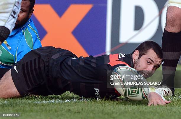 Toulouse's scrum-half Jean-Marc Doussain grabs the ball during the HCup rugby union match Treviso vs Stade Toulousain at the Comunal Stadio di...
