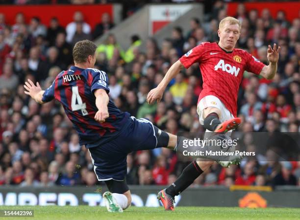 Paul Scholes of Manchester United clashes with Robert Huth of Stoke City during the Barclays Premier League match between Manchester United and Stoke...