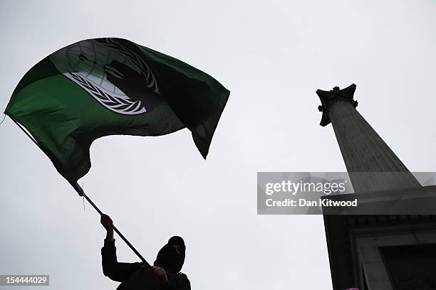 An anti-capitalist demonstrator waves a flag in Trafalgar Square on October 20, 2012 in London, England. Thousands of TUC members took part in a...