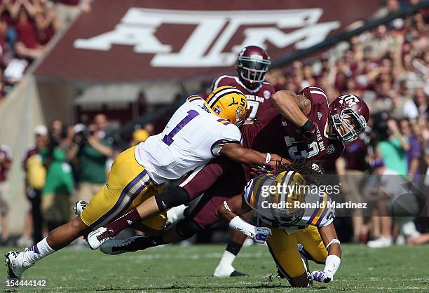 Mike Evans of the Texas A&M Aggies runs the ball against Eric Reid and Jalen Collins of the LSU Tigers at Kyle Field on October 20, 2012 in College...