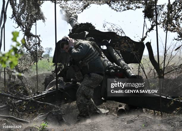 Ukrainian artilleryman fires a 152 mm towed gun-howitzer D-20 at Russian positions on the front line near Bakhmut, eastern Ukraine, on July 20 amid...