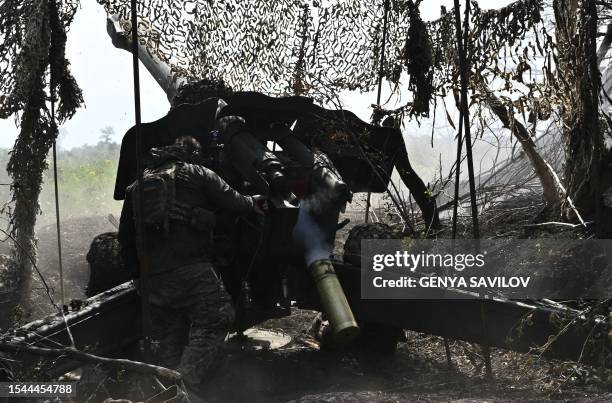 Ukrainian artilleryman fires a 152 mm towed gun-howitzer D-20 at Russian positions on the front line near Bakhmut, eastern Ukraine, on July 20 amid...