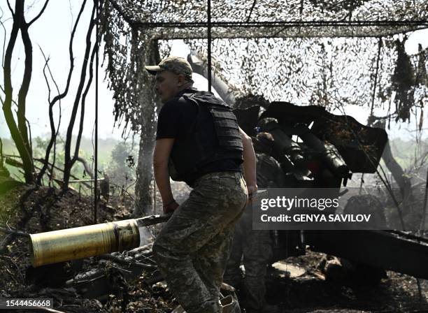 Ukrainian artillerymen fire a 152 mm towed gun-howitzer D-20 at Russian positions on the front line near Bakhmut, eastern Ukraine, on July 20 amid...