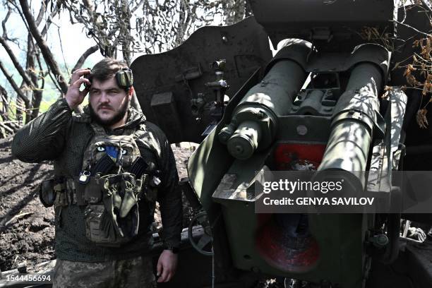 Ukrainian artilleryman stands next to a 152 mm towed gun-howitzer D-20 on the front line near Bakhmut, eastern Ukraine, on July 20 amid the Russian...