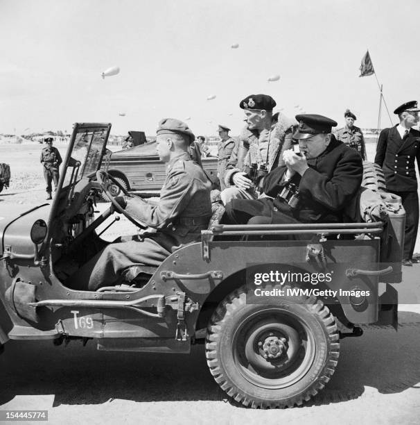 The Prime Minister Visits The Battle Front: Normandy 1944, The Prime Minister, Mr Winston Churchill, lights a cigar as he and General Montgomery set...