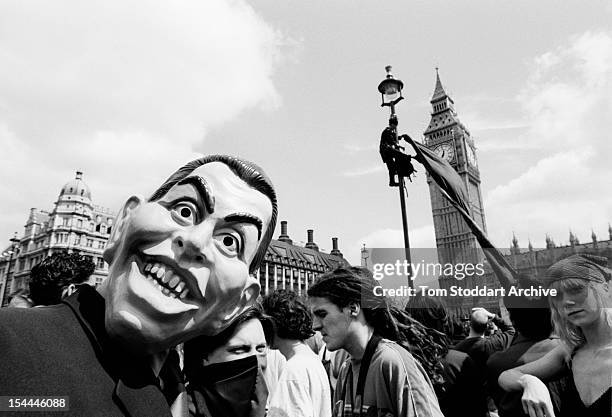 Demonstrator wearing a mask of Tony Blair takes part in a May Day anti-capitalist protest in Parliament Square in front of Big Ben, London, 1st May...