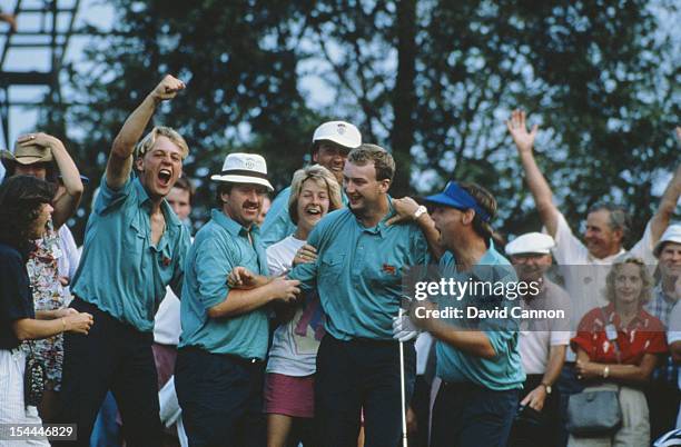 Jim Milligan of the Great Britain and Ireland team holes his chip on the 17th hole in his singles match against Jay Sigel during the Walker Cup...