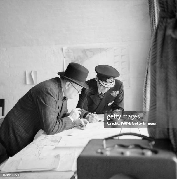 Winston Churchill During The Second World War, The Prime Minister Winston Churchill studies reports of the action that day with Vice Admiral Sir...