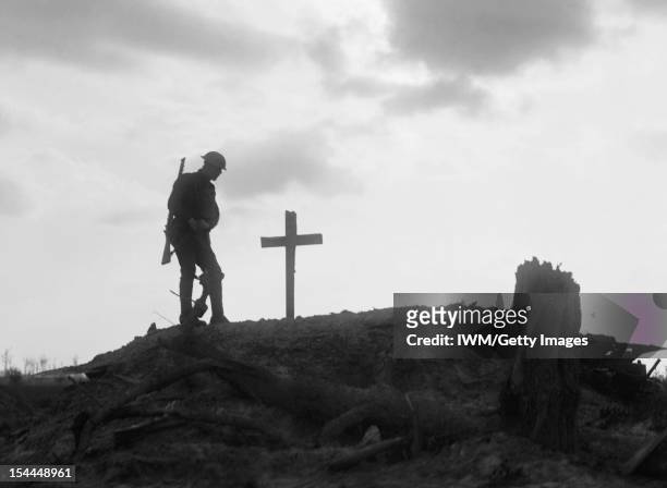 Ministry Of Information First World War Official Collection, A British soldier stands besides the grave of a comrade near Pilckem during the Third...