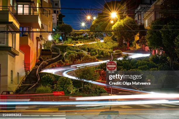 lombard street at night on long exposure showing car lights on a summer evening - lombard street san francisco stock pictures, royalty-free photos & images