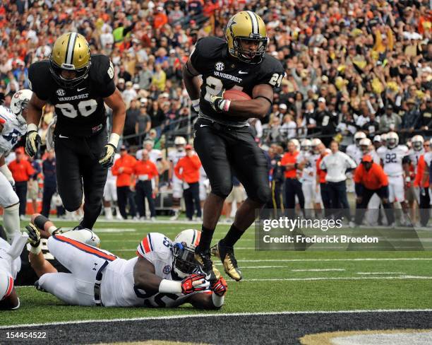 Wesley Tate of the Vanderbilt Commodores jumps over Jonathan Evans of the Auburn Tigers to score a touchdown at Vanderbilt Stadium on October 20,...