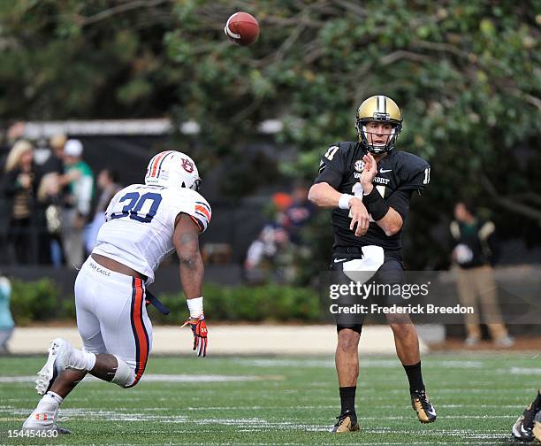 Quarterback Jordan Rodgers of the Vanderbilt Commodores passes over the head of Cassanova McKinzy of the Auburn Tigers at Vanderbilt Stadium on...