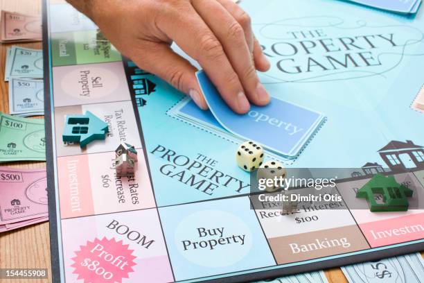 player taking card from property board game - brettspiel würfel stock-fotos und bilder