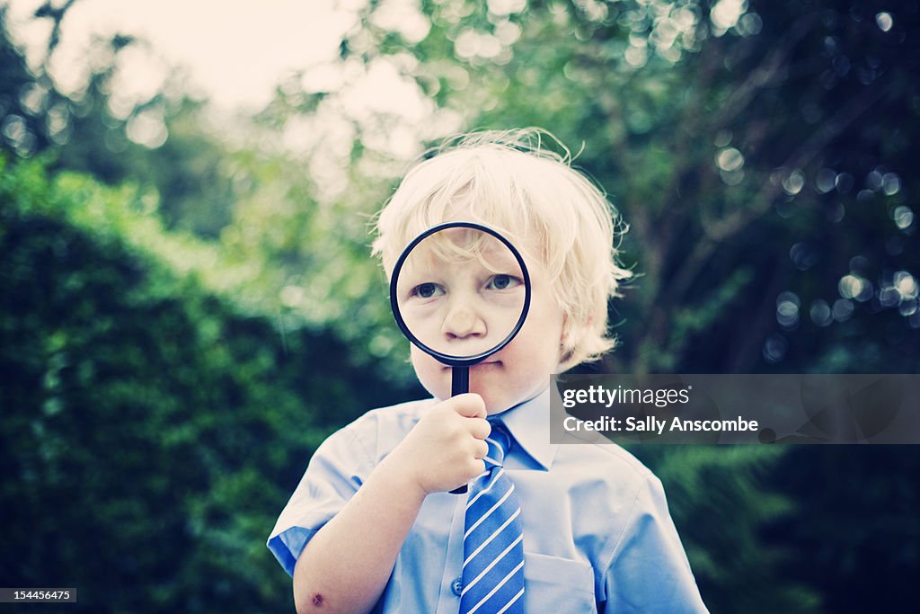 School boy with a magnifying glass