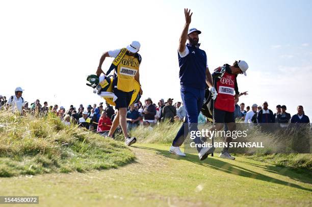 Golfer Dustin Johnson walks from the 15th tee on day one of the 151st British Open Golf Championship at Royal Liverpool Golf Course in Hoylake, north...