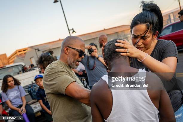 Members of the Judah Arise Ministries pray over a homeless resident in a section of the 'The Zone' encampment on July 14, 2023 in Phoenix, Arizona....