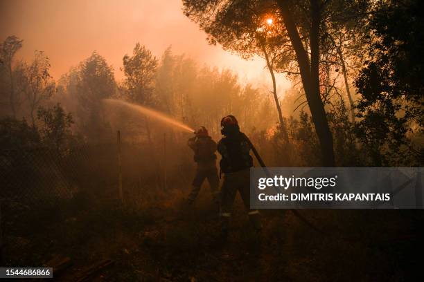 Firefighters try to extinguish a wildfire at Agios Sotiras, a village 35 km West of Athens, on July 20, 2023. Forest fires are burning for the 4th...