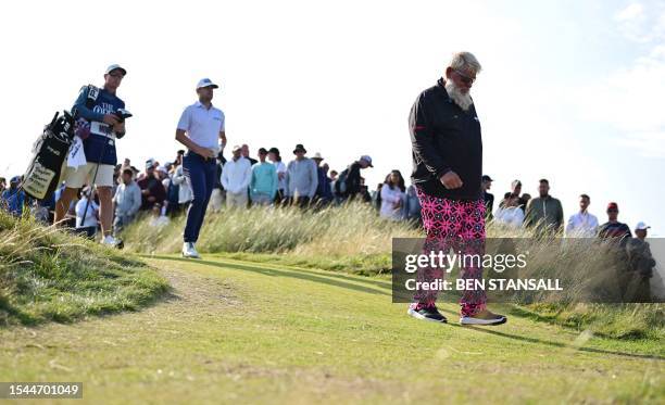 Golfer John Daly leaves the 15th tee on day one of the 151st British Open Golf Championship at Royal Liverpool Golf Course in Hoylake, north west...