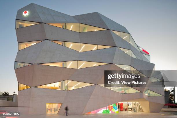 Vodafone Headquarters Building, Barbosa & Guimaraes Architects, Porto, Portugal Front Elevation Of Angular Structure With Lit Interior At Dusk,...