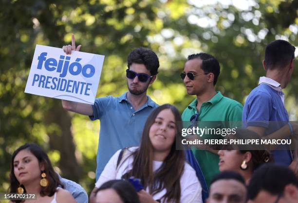 Supporter holds a banner reading 'Feijoo President' prior a campaign meeting of Spanish right-wing opposition party Partido Popular leader in Madrid...