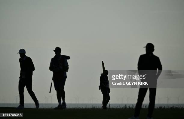Golfer Keegan Bradley walks on the 13th green on day one of the 151st British Open Golf Championship at Royal Liverpool Golf Course in Hoylake, north...