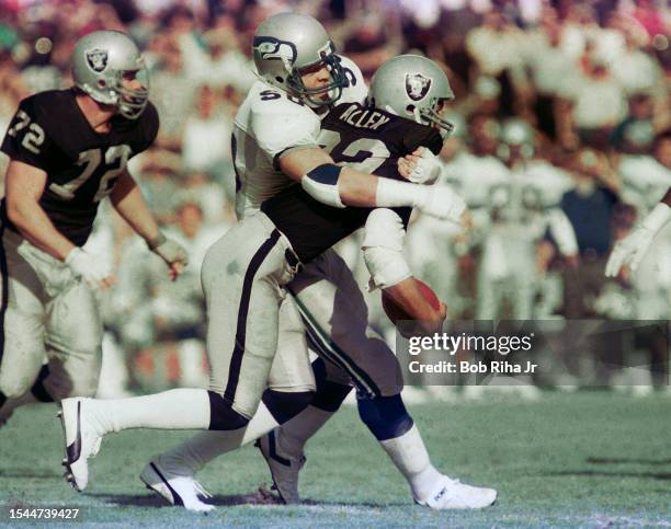 Los Angeles Raiders Running Back Marcus Allen runs to elude defenders during game action against Seattle Seahawks, December 15, 1985 in Los Angeles,...