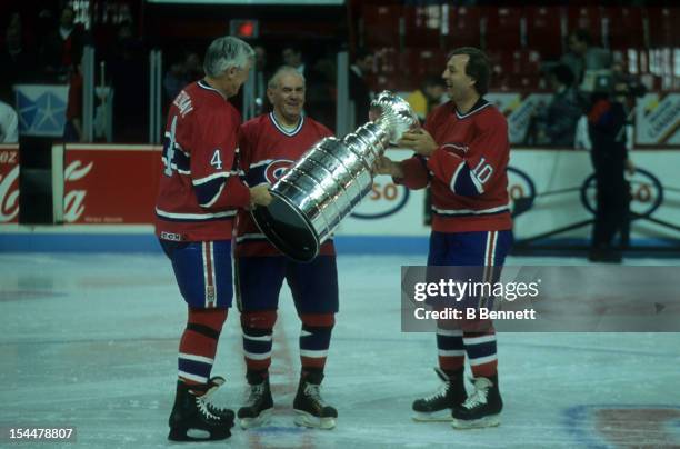 Former Montreal Canadiens Jean Beliveau, Henri Richard and Guy Lafleur hold up the Stanley Cup Trophy before the 1993 44th NHL All-Star Game with the...