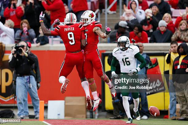 Damian Copeland of the Louisville Cardinals celebrates with DeVante Parker after making a 21-yard touchdown reception in the third quarter against...