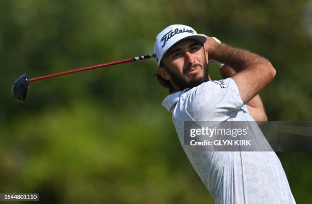 Golfer Max Homa watches his drive from the 15th tee on day one of the 151st British Open Golf Championship at Royal Liverpool Golf Course in Hoylake,...