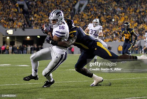 Tyler Lockett of the Kansas State Wildcats runs after the catch against Darwin Cook of the West Virginia Mountaineers during the game on October 20,...