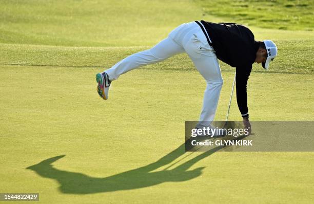 Japan's Keita Nakajima collects his ball after putting on the 18th green on day one of the 151st British Open Golf Championship at Royal Liverpool...
