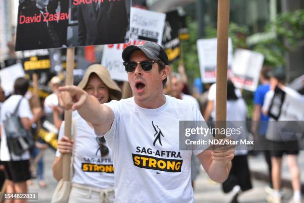 Chris Lowell walks the picket line in support of the SAG-AFTRA and WGA strikes on July 20, 2023 in New York City.