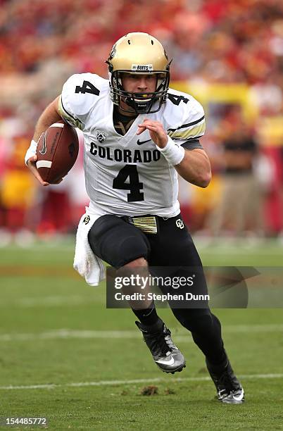 Quarterback Jordan Webb of the Colorado Buffaloes carries the ball against the USC Trojans at the Los Angeles Memorial Coliseum on October 20,2012 in...