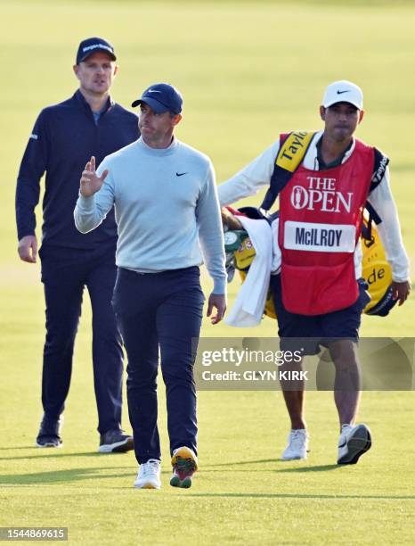 England's Justin Rose and Northern Ireland's Rory McIlroy leave the 18th green on day one of the 151st British Open Golf Championship at Royal...