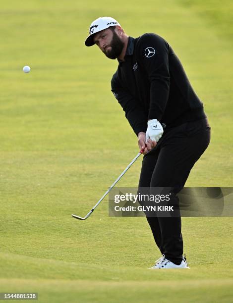Spain's Jon Rahm chips onto the 18th green on day one of the 151st British Open Golf Championship at Royal Liverpool Golf Course in Hoylake, north...