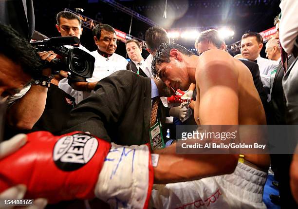 Erik Morales is tended to as he sits on a stool after being knocked out in the fourth round by Danny Garcia during their WBC/WBA junior welterweight...