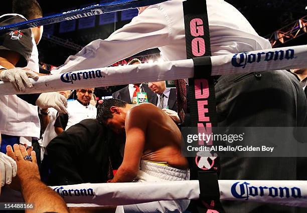 Erik Morales is tended to as he sits on a stool after being knocked out in the fourth round by Danny Garcia during their WBC/WBA junior welterweight...