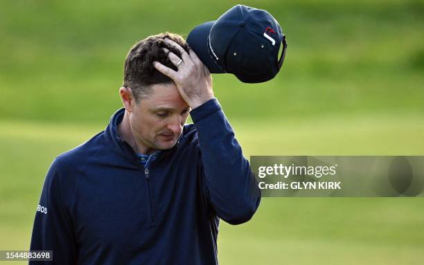 Rose reacts after putting on the 18th green on day one of the 151st British Open Golf Championship at Royal Liverpool Golf Course in Hoylake, north...