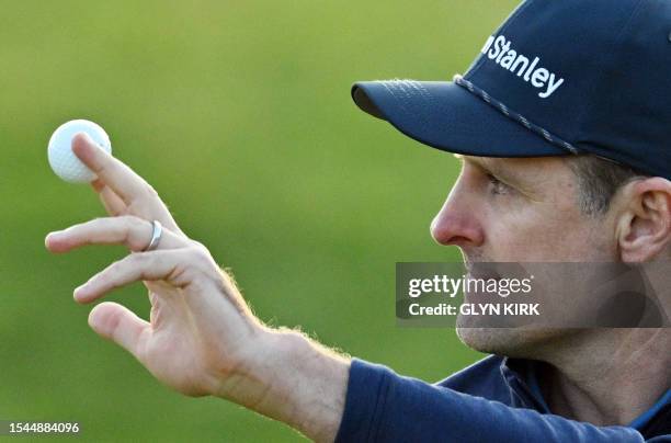 England's Justin Rose holds aloft his ball after putting on the 18th green on day one of the 151st British Open Golf Championship at Royal Liverpool...