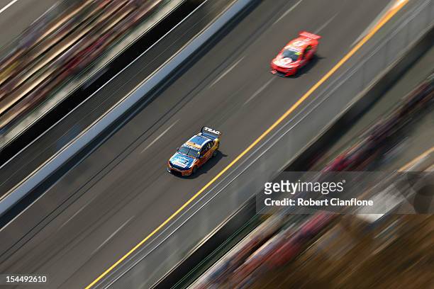 Mika Salo of Finland driving the Tradingpost FPR Ford is chased down by Richard Lyons of Great Britain during race 23 of the Gold Coast 600, which is...