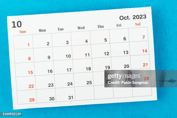 calendar desk 2023: october is the month for the organizer to plan and deadline with a blue paper background. - outubro imagens e fotografias de stock